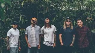 Dirty Heads band members outdoors in front of lush greenery