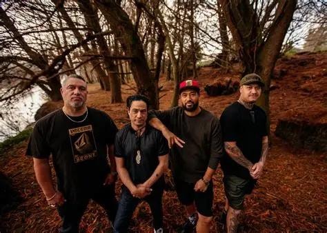 Katchafire band members posing together in a wooded setting